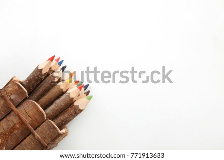 colorful wooden pencils on white surface in the studio