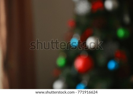 In the background a blurred Christmas tree, window, Christmas motifs - background for Christmas and New Year greetings, announcements, advertisements.