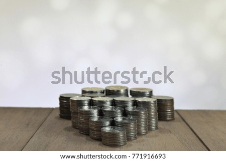 coin stacked pile closely together on wood table. Business, money, saving and financial concept. 