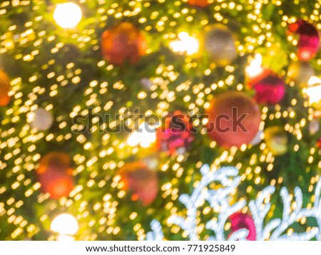 blur image of artificial pine christmas tree , bokeh of LED decorative light defocused background and textured,  for Christmas Eve , New Year party holiday and celebration background