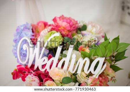 White wooden wedding word on flowers background