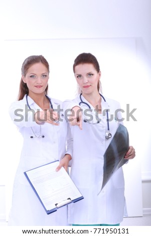 Two woman nurse watching X Ray image, standing in hospital. X Ray . Two woman doctor
