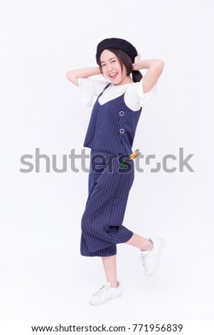 Portrait of young Asian female artist, or pretty girl with Artist hat or pure wool Beret Hat with Artist bib uniform smiling with her paintbrush or artist brush (isolated on white background)