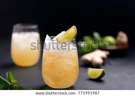 Fresh cocktail prepared with ginger beer, lime and ice. Beverage on the table Royalty-Free Stock Photo #771991987