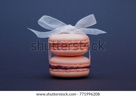 Sweet and vintage pastel colored french macaroons or macarons on different color background, Dessert.