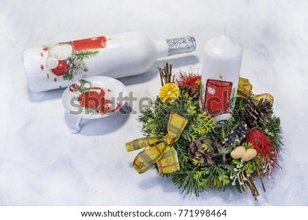 Christmas decoration on wooden tray with red candles.