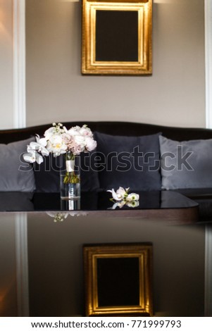 Wedding bouquet in a vase on a mirror table.