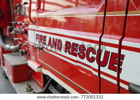 close-up on fire and rescue words on the red fire truck Royalty-Free Stock Photo #772001332