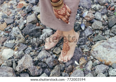 feet are painted mehendi. feet are painted mehendi on stones.  feet of mehendi stones