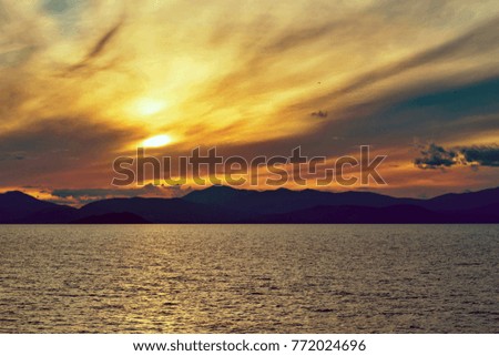 magnificent sea landscape and sunset on the big yellow sky with clouds