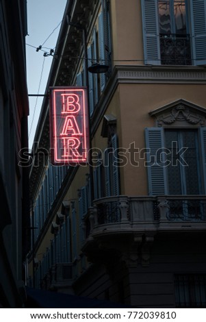 Bar neon light sign with ancient buildings in the background