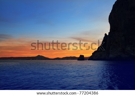 Cape San Antonio Javea Xabia sunset view from sea Mediterranean backlight Alicante Spain