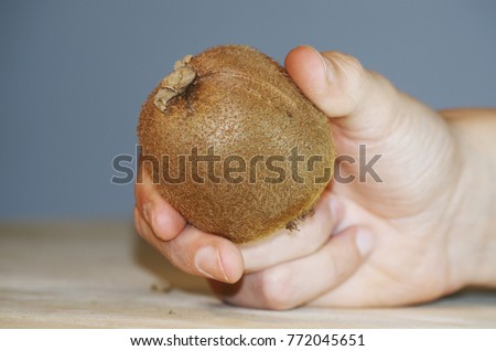 Hand with kiwi fruit