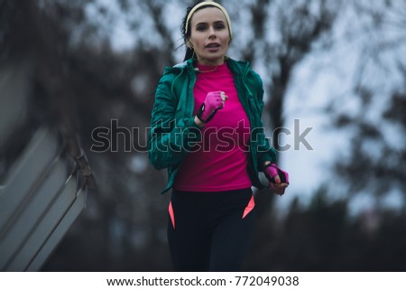 Woman jogging outside in cold winter day