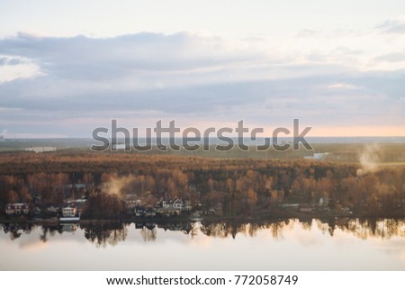view of the forest, houses during the sunset. evening