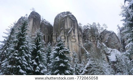 Rocks in the famous rocky city of Adrspach-Teplice rocks. Winter time trees, road, tourist routes and rocks covered with snow. known and popular place among tourists in the Czech Republic.