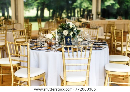 Table set for wedding or another catered event dinner. Royalty-Free Stock Photo #772080385