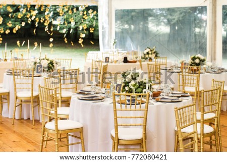 Tables sets for wedding or another catered event dinner. Royalty-Free Stock Photo #772080421
