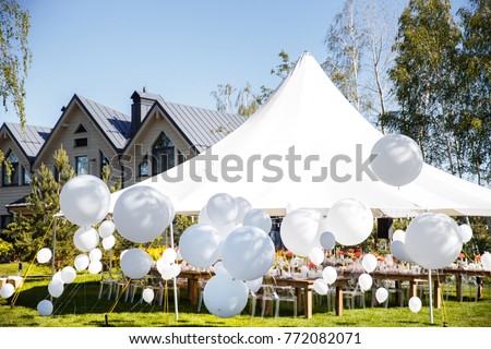 Wedding tent with large balls. Tables sets for wedding or another catered event dinner. Royalty-Free Stock Photo #772082071