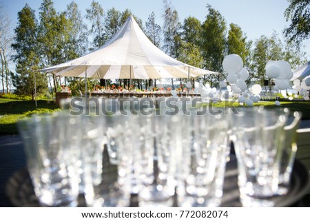 Wedding tent with large balls. Tables sets for wedding or another catered event dinner. Royalty-Free Stock Photo #772082074