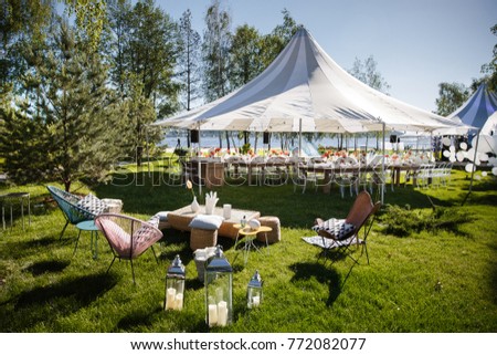 Wedding tent with large balls. Tables sets for wedding or another catered event dinner. Royalty-Free Stock Photo #772082077