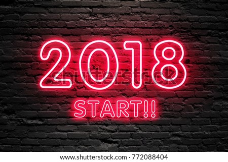 GET READY FOR 2018 NEW YEAR concept. 2018 START text fluorescent Neon tube Sign on dark brick wall. Front view. Can be used for online banner ads or background. night moment.