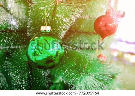 Close up image of green ball and Christmas  ornaments hanging on the Christmas tree with copy space for your text design. Concept be used for Christmas day and vintage style. Blur picture.