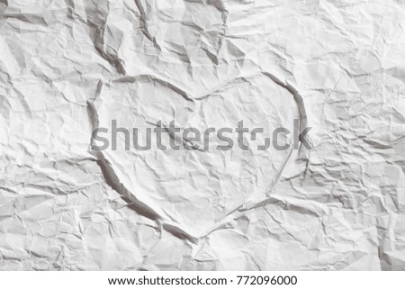 the contour of a big heart on a crumpled sheet of white paper on Valentine's Day