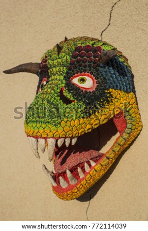 Carnotaurus. Sculpture of a dinosaur head. Decorative sculpture made of paper.