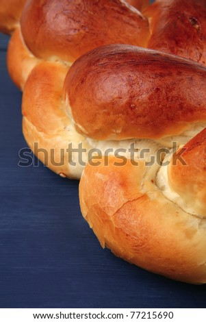baked product : golden challah on blue wooden table