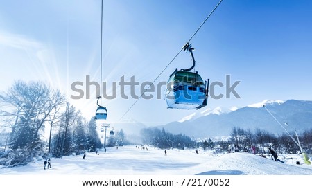 Gondola lift at ski resort in winter. Pirin Mountains. Ropeway station in Bansko Royalty-Free Stock Photo #772170052