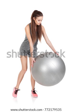 beautiful woman in sportswear with fitness ball isolated on white background