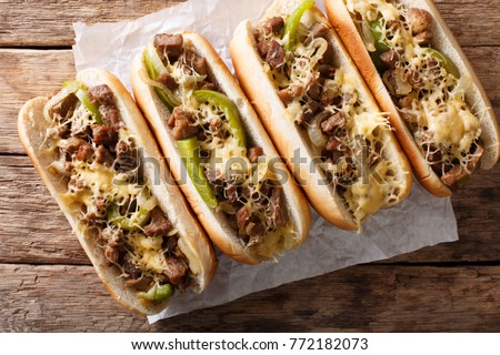 Philly cheese steak sandwich served on parchment paper close-up on the table. Horizontal top view from above
 Royalty-Free Stock Photo #772182073
