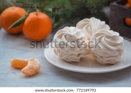 Tangerines flavour marshmallows or zephyr Christmas treat with branches of a fir tree