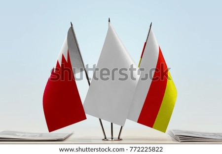 Flags of Bahrain and South Ossetia with a white flag in the middle
