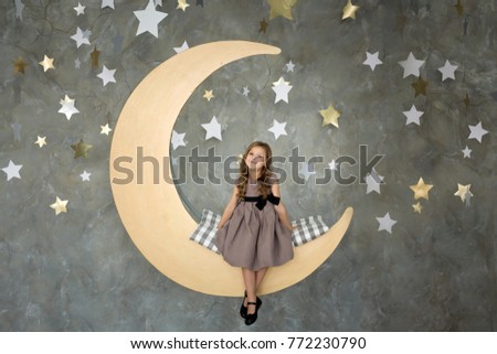 portrait of a happy little girl on a background of stars
