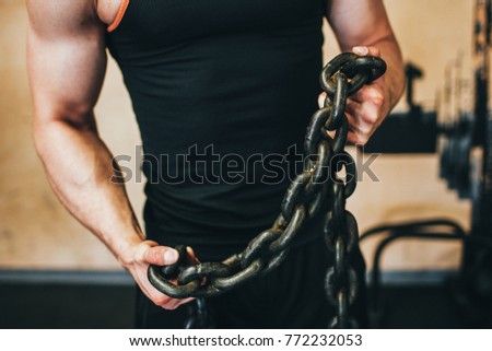 Strong man gym sport bodybuilder concept. Break the shackles of laziness. Athlete lifestyle.