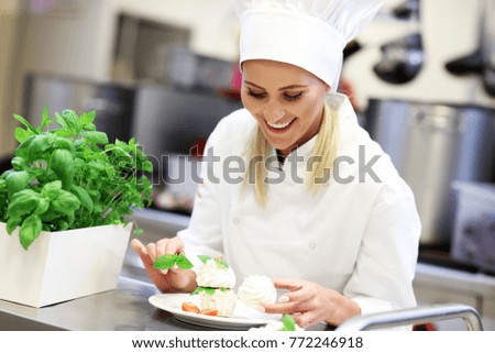 Picture showing busy chef at work in the restaurant kitchen