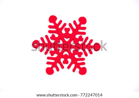 Red artificial Christmas snowlake on the white background