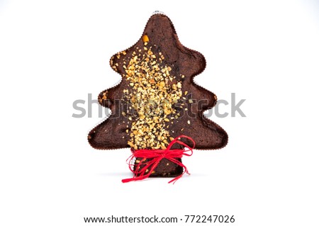 Red stripe on the gingerbread tree with nuts on the white background