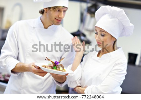 Picture showing busy chefs at work in the restaurant kitchen