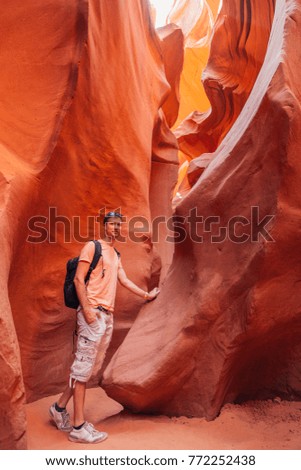 Young man exploring Antelope Canyon in the Navajo Reservation near Page, Arizona USA. Beautiful life. Amazing orange caves and cliffs in Arizona.