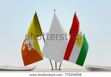 Flags of Bhutan and Kurdistan with a white flag in the middle