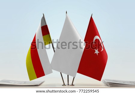 Flags of South Ossetia and Turkey with a white flag in the middle