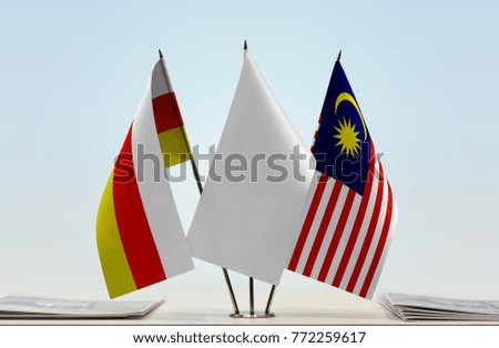 Flags of South Ossetia and Malaysia with a white flag in the middle