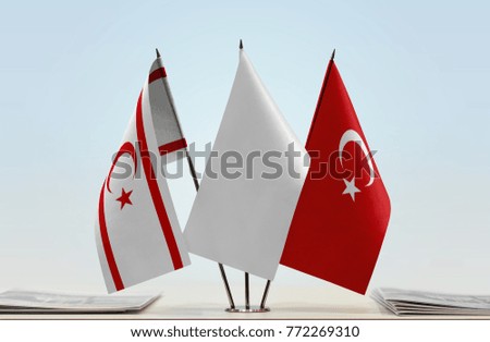 Flags of Northern Cyprus and Turkey with a white flag in the middle