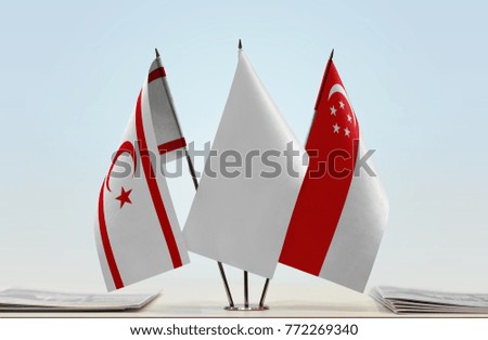Flags of Northern Cyprus and Singapore with a white flag in the middle