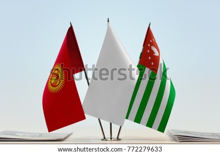 Flags of Kyrgyzstan and Abkhazia with a white flag in the middle
