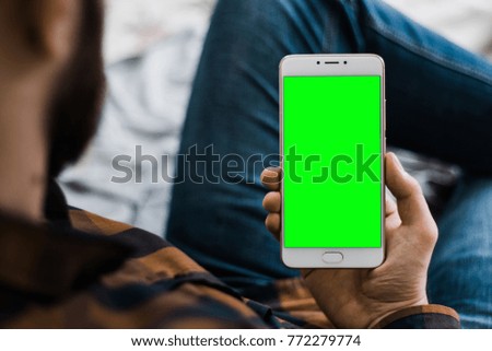 holding a smartphone in the hands of a green screen green screen, hand of man holding mobile smart phone with chroma key green screen on white background, new technology concept