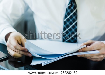 Businessman working with documents Royalty-Free Stock Photo #772282132